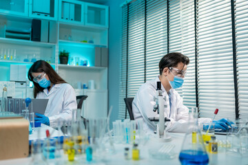 Asian male and female scientis work together in the research laboratory. 