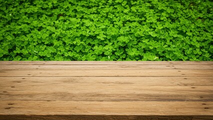 Fototapeta premium Wooden table with clovers, a vibrant green backdrop. Room for product placement.
