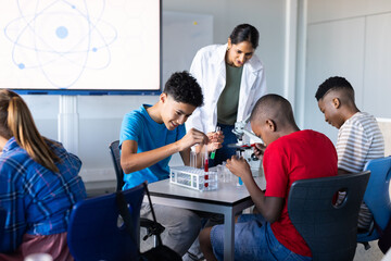 In school, students conducting science experiments with test tubes and microscope