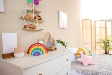 Toys with plant on commode in children's room