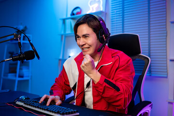 Asian young esport male gamer playing online video game on computer.  © Kawee