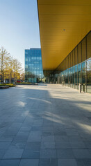 Fototapeta premium Modern Architecture: Glass Building & Plaza - Clean Lines, Contemporary Design, Urban Landscape, Office Space, Exterior View