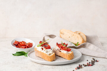 Plate of tasty tomato bruschetta with ricotta and peppercorn on white background