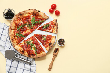 Composition with tasty pizza and cutter on beige background