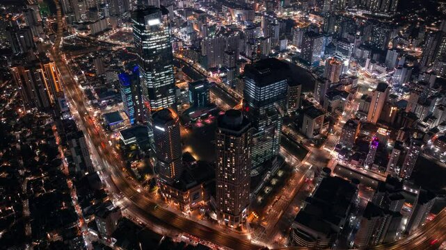 Aerial hyperlapse of skyscrapers and traffic in downtown Busan, Seomyeon district in South Korea at night