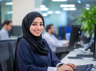 Smiling Woman in Hijab Typing on Keyboard in Modern Office Setting