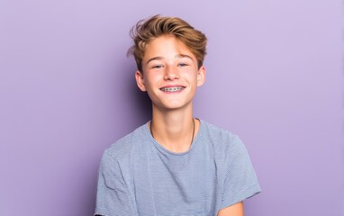 A teenage boy with cute smile and braces, pastel lilac background