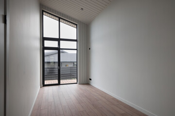 A Modern Minimalist Room Featuring Large Window Views That Enhance the Aesthetic Ambiance