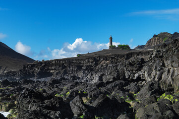 Farol da Ponta dos Capelinhos lighthouse at Faial island of the Azores, Portugal. Former beacon on the Atlantic Ocean coast. Eruption of Capelinhos volcano.