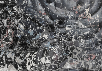 A warm neutral abstract of paint chips on a wall.