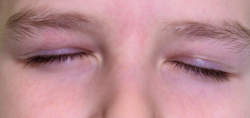 Fototapeta premium boy with closed eyes. close-up part of face