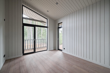The Modern Interior of an Unfurnished Room featuring Large Windows for Ample Light