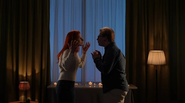 Couple Engaging In Intense Discussion By Candlelight