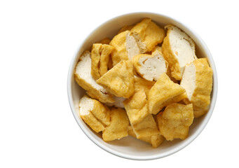 Close-up of deep-fried tofu in a white bowl, isolated a bowl of deep-fried tofu on a white background. Top view vegan food image.