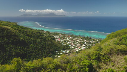 Aerial view of Tahiti tropical island with lush green forest hills, turquoise lagoon, coral reef...