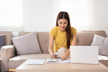 A smart business woman who keeps a paper account using a calculator, housewife manages the...