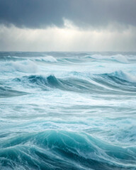 Fototapeta premium Dramatic Ocean Waves Under Cloudy Sky Capturing a Stormy Seascape Moment