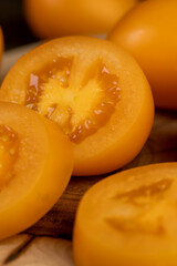 orange tomatoes cut into pieces, clean washed tomatoes are sliced for salad preparation