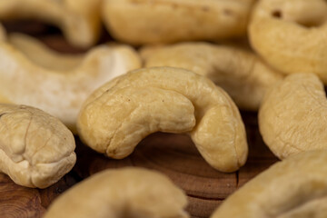 cashew are scattered on a board, cashew nuts are healthy