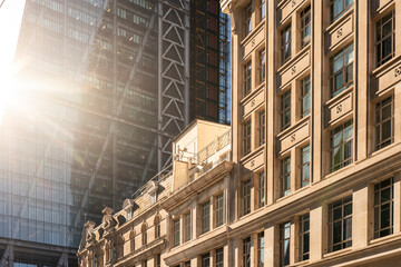 Low-angle sunlight on office buildings in financial district, capturing legacy, transformation and strategic outlook.