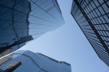 Upward angle of glass buildings in financial quarter, reinforcing ambition, real estate and global connectivity.