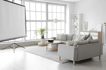 Interior of living room with sofas, table and projector