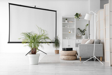 Interior of living room with sofa, poufs and projector