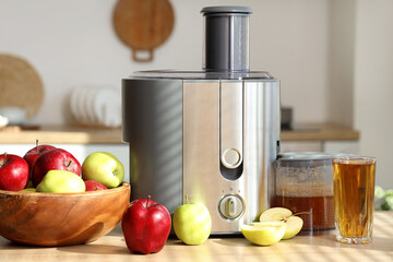 Modern juicer with apples on table in kitchen, closeup