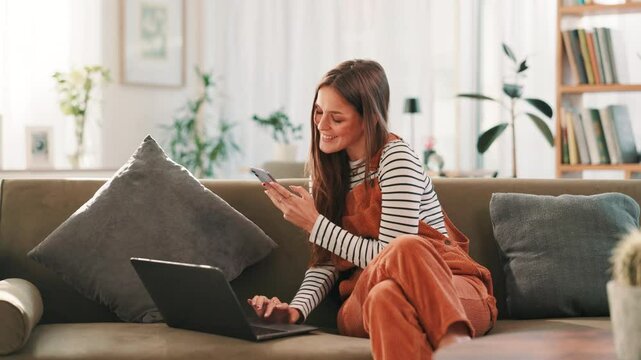 Woman, phone and laptop on sofa in home with online shopping, happy and scan code for easy payment. Person, smartphone and computer with smile for deal, sale and mobile app for fintech with ecommerce