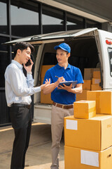 Asian man signs for parcel delivery, confirming shipment. Concept of e-commerce, logistics, and...