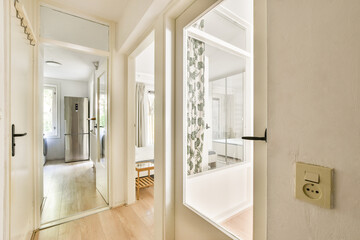 Bright and airy interior space showcasing a minimalist design with large mirrors and natural light illuminating the area.