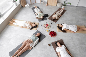 Group of young meditating girls during women circle training, top view