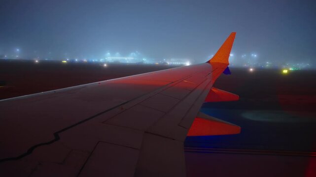 Airport LAX, Los Angeles, California, USA - MARCH 18, 2025: The view seen from the airplane window shows fog and rain as the plane taxiing smoothly to the gate after having successfully landed
