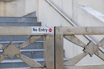 No entry sign on stainless steel gate.