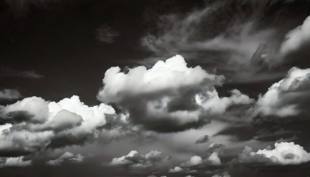 A black and white photo of a cloudy sky with a few clouds that are white