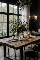 A wooden dining table with a vase of flowers and candles on it