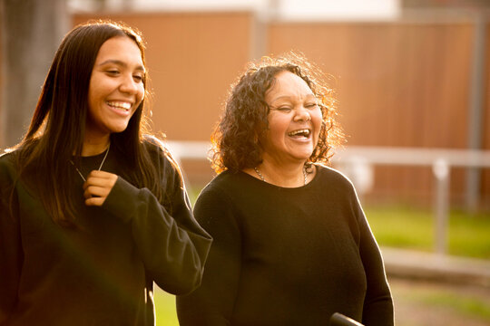 two women wearing black sweaters laughing
