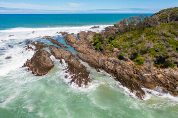 Aerial view of waves crashing on a rocky coastline