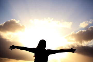 Silhouette of girl with arms outstretched