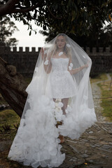 An Elegant Bride with a Unique Veil Gracing an Outdoor Setting on Her Special Day