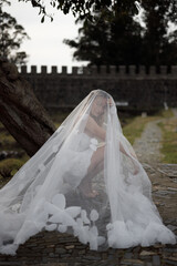 An Elegant Bride with a Unique Veil Gracing an Outdoor Setting on Her Special Day