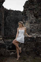 A Bride Dressed in an Elegant White Gown Amidst Stunning Ancient Ruins and Landscapes