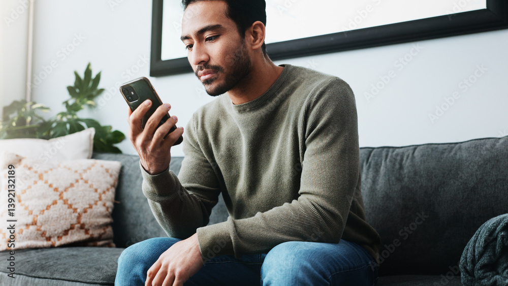 Poster man, phone and relax with texting on sofa, home and check notification for web chat in living room. 