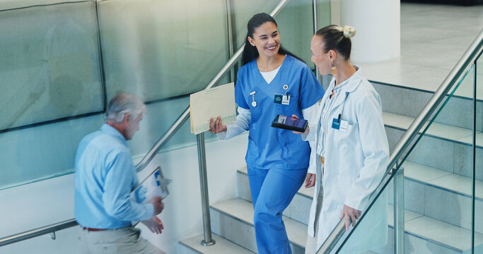 People, stairs and doctors in hospital, conversation and smile with advice, feedback or talking. Medical, women or professional in clinic, discussion or communication with mentor, steps or healthcare