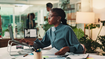 Business woman, laptop and documents with design for creative development or project planning at...