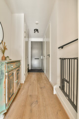 A contemporary hallway featuring a wooden floor, stylish decor, and an elegant console table that enhances the modern aesthetic of the space.