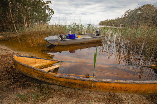 Partially submerged yellow rowboat on the shore at Mungo Brush
