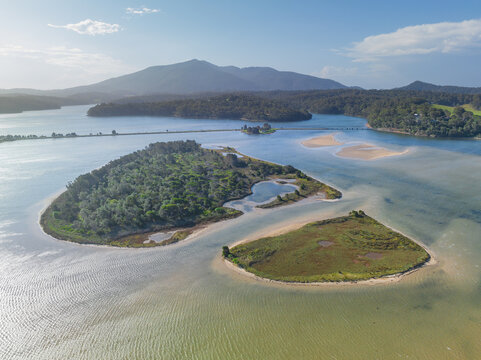 Aerial view of sand bars and islands in a freshwater lake with distant mountain