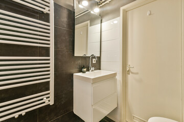 A sleek and modern bathroom showcasing minimalist design, featuring stylish fixtures and a contemporary aesthetic. Perfect for a functional yet elegant space.