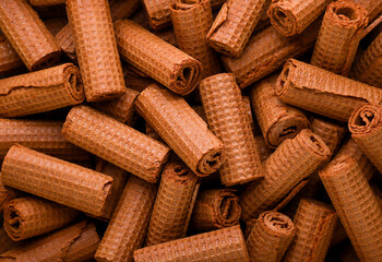 Chocolate wafer rolls background. Top view